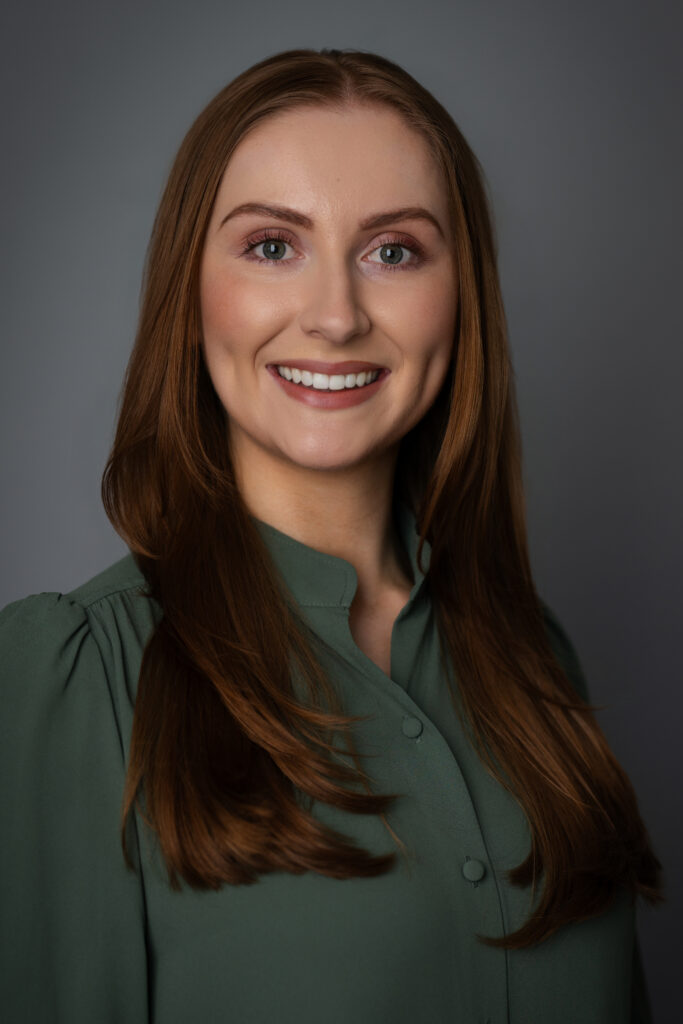 A modern corporate portrait of Caroline featuring a warm, approachable expression suitable for LinkedIn and company websites.