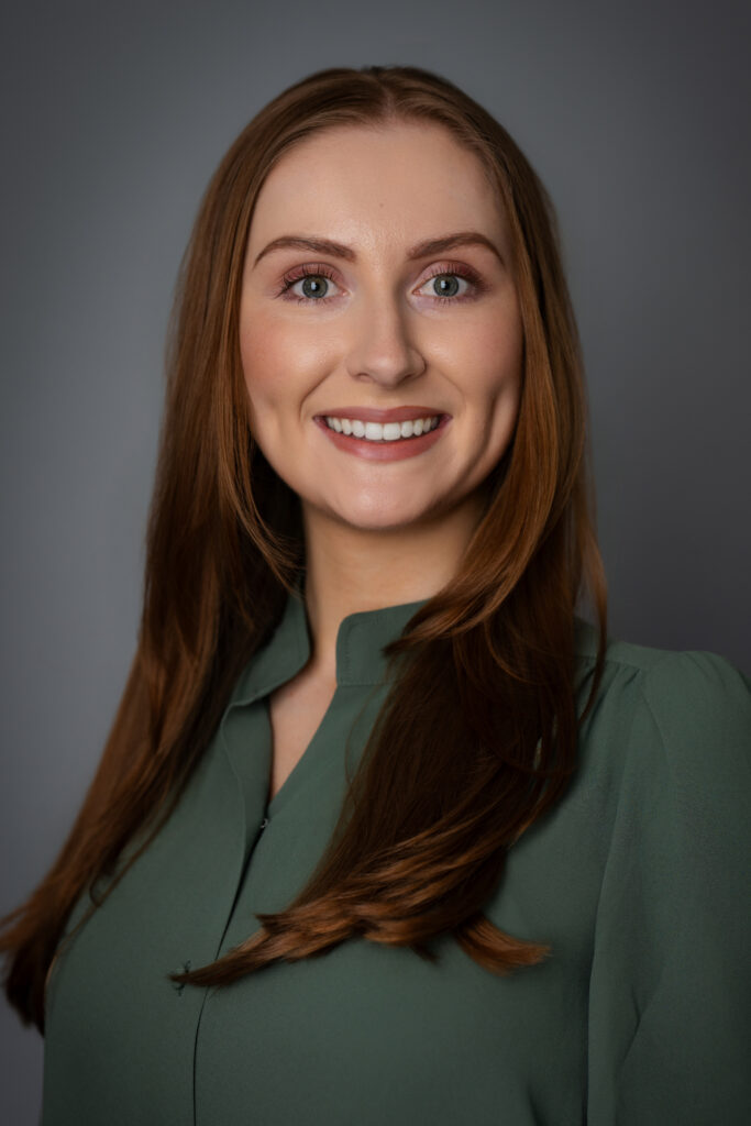 An elevated professional headshot of Caroline, capturing a genuine and trustworthy presence through refined styling and natural lighting.
