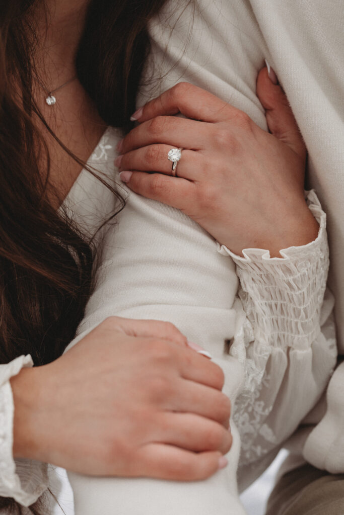 A close-up detail shot of Savannah’s engagement ring as she rests her hand on Joe’s arm, highlighting the "exciting season of life" being documented.